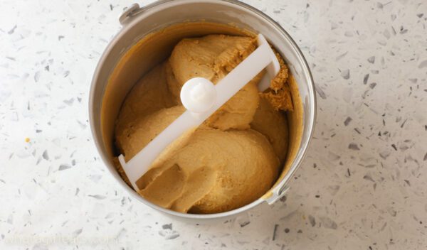 pumppkin spice ice cream in churner pumpkin spice ice cream in container.