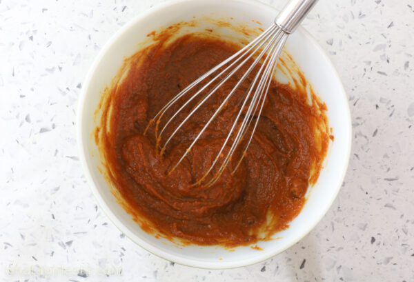 whisking pumpkin and brown sugar whisking pumpkin and brown sugar with egg yolks.