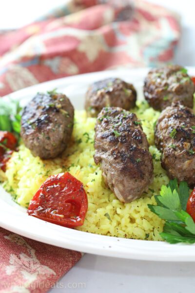 Lamb kebabs on bed of rice.