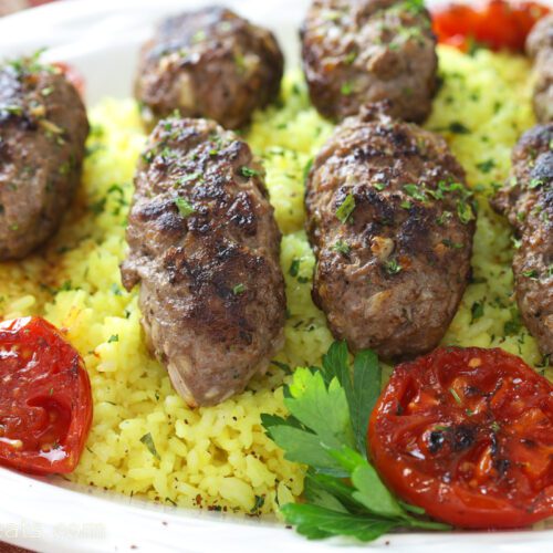 Lamb kebabs on bed of rice.