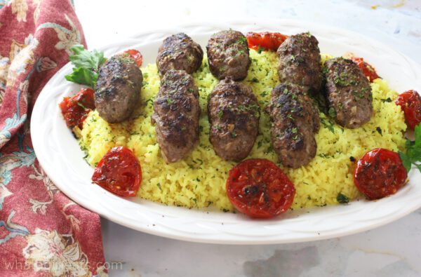 Lamb kebabs on platter.